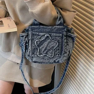 Blue denim crossbody bag with vintage star pocket detail for casual daily styling