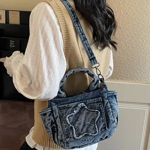 Women's vintage washed denim handbag with star pocket for casual everyday cross-body use