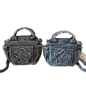 Large denim tote bags in grey and blue with frayed star patches and crossbody straps