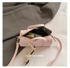 Internal capacity of pink Boston bag showing space for phone and makeup accessories