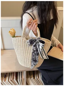 Detailed straw tote bag with hand-woven texture, floral silk scarf and elegant Paris print