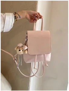Pink PU leather backpack featuring a magnetic flap, drawstring closure and puppy charm