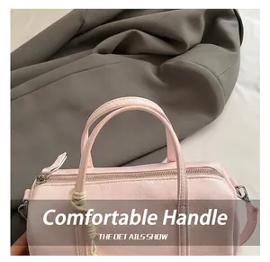 Detail showing the light pink PU leather texture and top zipper of the Boston handbag