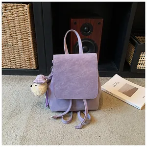 Lavender frosted texture backpack with top handle and cute beige plush bear pendant detail