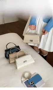 Minimalist square handbags in black, coffee, and cream colors with silver buckles