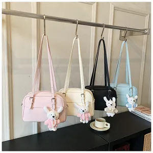 Litchi pattern crossbody bags in four colors with cute rabbit pendant decorations