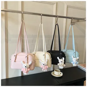 Detailed row of lychee pattern crossbody bags in pastel tones with rabbit charm