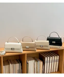 Four elegant leather handbags in white, khaki, brown, and black on a wooden shelf