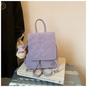 Detail of light purple mini backpack with drawstring closure and cute bear plush charm