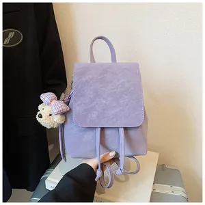 Close-up of light purple PU leather backpack with drawstring closure and white bear charm