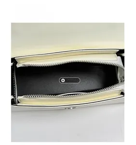 Internal view of a stylish white handbag featuring a spacious black main compartment