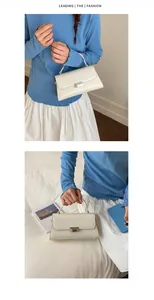 Detail of white glossy synthetic leather handbag with silver metal lock and top handle
