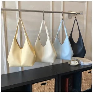 Selection of large capacity tote bags in yellow, cream, blue, and black leather styles