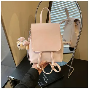 Pink faux leather backpack with drawstring closure, flap cover and cute teddy bear charm