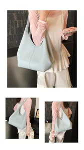 Detailed view of light blue tote bag showing soft pebbled leather texture and stitching