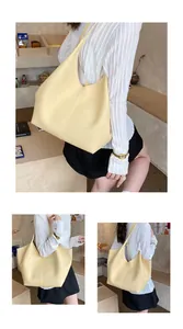 Close-up of large yellow tote bag featuring premium lychee pattern leather texture