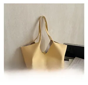 Detail of lychee textured leather tote bag in cream yellow for daily commuting use
