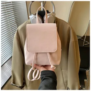 Detailed view of the soft pink PU leather mini backpack with drawstring and flap closure