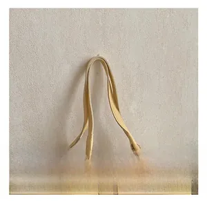 Close-up of the reinforced stitching on the yellow pebble leather tote bag handle