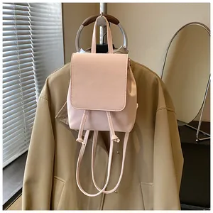 Detail of pink mini backpack in matte synthetic leather with drawstring and top handle