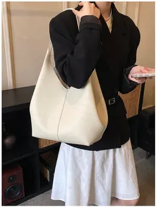 Close-up of cream white tote bag featuring premium lychee texture leather and V-cut design