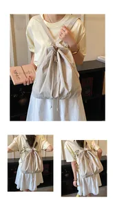 Detail view of the drawstring closure and soft cream fabric on a versatile canvas backpack