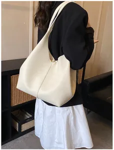 Detailed view of large ivory hobo tote bag with pebble leather texture and shoulder strap