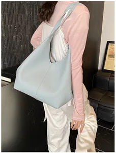 Detail of light blue hobo tote bag featuring lychee texture and vertical stitching detail