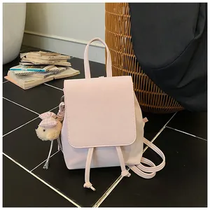 Pink PU leather backpack featuring a cute plush bear charm and drawstring detail