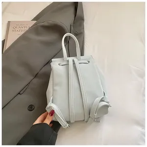 Close-up of light blue mini backpack showing adjustable straps and smooth PU leather texture