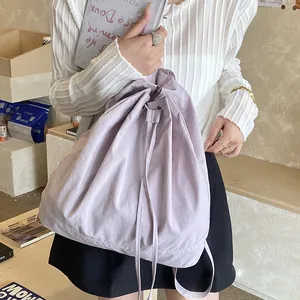 Close-up of light purple drawstring backpack with soft nylon fabric and pleated texture