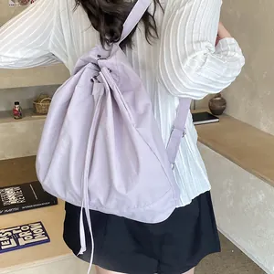 Close-up of light purple water-resistant nylon drawstring backpack with adjustable straps