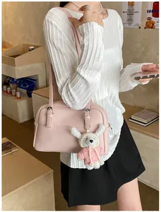 Detailed view of pink lychee texture shoulder bag with cute white bear plush charm