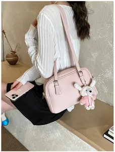 Detail of pink lychee texture shoulder bag with cute white rabbit plush pendant charm