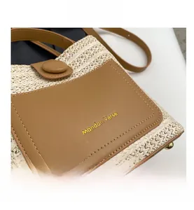 Close-up of woven straw texture and premium brown leather pocket with gold logo detail