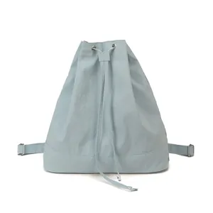 Minimalist light blue drawstring backpack with adjustable straps and silver metal buckles