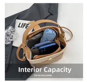 Internal capacity of straw bucket bag showing space for phones and a folding umbrella