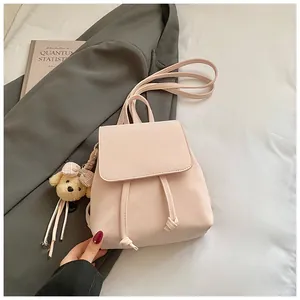 Pink PU leather mini backpack detail with drawstring closure and cute plush bear charm
