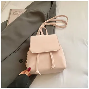 Close-up of pink PU leather backpack featuring drawstring detail and elegant flap closure