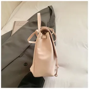 Side view of pink PU leather backpack with drawstring closure and metal eyelet details