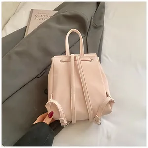 Detail view of pink PU leather mini backpack showing slim straps and drawstring closure
