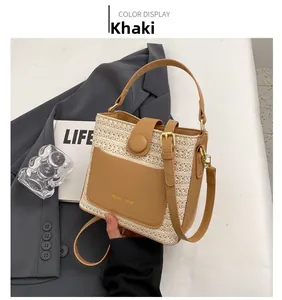 Close-up of khaki leather trim and woven straw detail on a stylish bucket bag