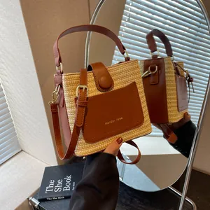 Straw bucket bag with brown leather trim and adjustable strap in minimalist Korean style