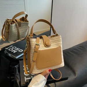 French style straw bucket bag with brown leather pocket and Mandan Verse logo