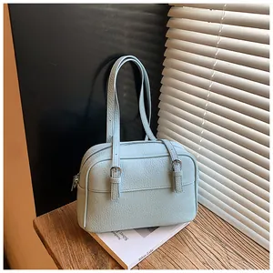 Detailed macro view of the light blue lychee pattern leather and silver hardware zipper