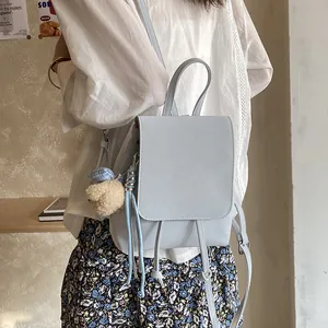 Minimalist light blue backpack with drawstring flap and cute plush bear charm for women