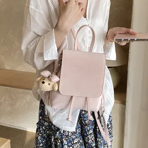 Minimalist light pink PU leather backpack for women with cute plush bear keychain