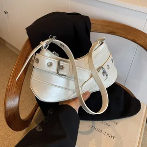 Y2K style cream white underarm bag with silver buckles and grommet details