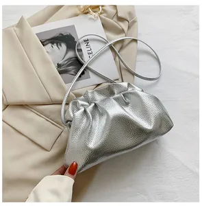 Detailed top view of a silver metallic crossbody bag with stylish pleated cloud design