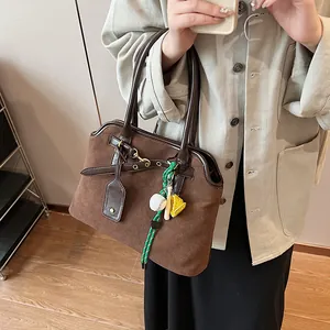Retro dark brown frosted leather shoulder bag with decorative straps and sports charm